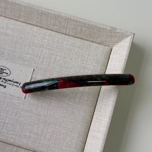 Detailed close-up of a vintage tortoise shell acetate hair clip with a polished finish