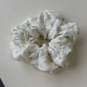 Floral embroidered white scrunchie with blue flower patterns for a soft forest style look