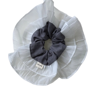 Elegant double-layered white ruffled scrunchie with handmade tag for voluminous hairstyles