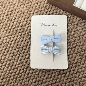 Set of light blue floral and striped bow hair clips for girls on display card