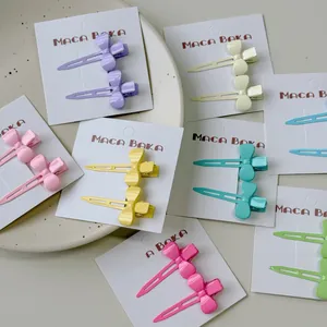 Close-up of macaron candy color bow hair clips set on a display card in pastel shades