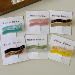 6 pairs of wave-shaped acetate hair clips in assorted colors and marble patterns