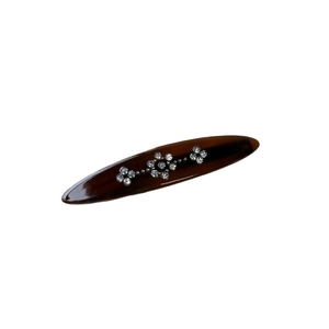 Retro tortoise shell hair clip with crystal flower patterns on a white background