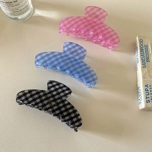 Three-piece checkered acetate hair clips in pink, blue, and black gingham patterns