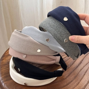Set of six wide knit headbands in various colors with small heart-shaped metal accents