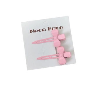 Set of two pastel pink bow hair clips on a white background for a minimalist Korean style