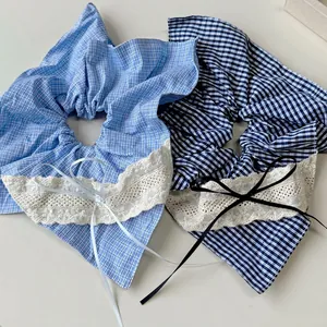 Plaid scrunchies with white lace edges and delicate silk bows in light and dark blue