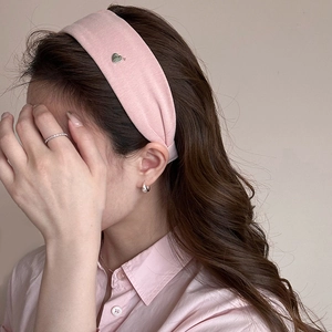 Pink wide headband with silver heart pendant on a model with matching pink shirt