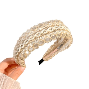 Bohemian style beige woven headband with white scalloped lace edges for a vacation look