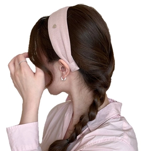 Pink fabric wide headband for women featuring a high top design on a model