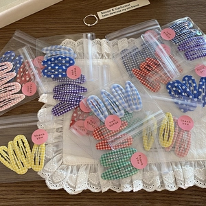 Cute Korean style plaid and polka dot BB hair clip set for girls on lace fabric