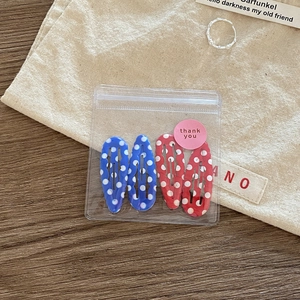 Set of four cute polka dot hair clips in red and blue colors for girls and students