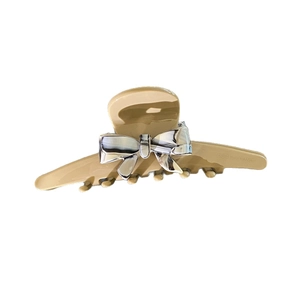 Elegant beige bow hair claw clip made of acetate with silver mirror finish butterfly detail