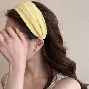 Close-up of yellow pleated chiffon headband showing detailed wavy fabric texture