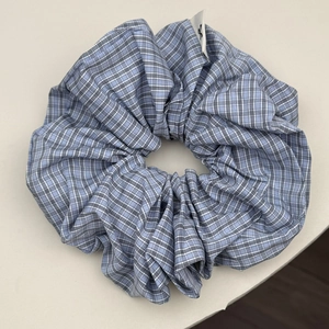 Blue and white checkered oversized scrunchie with stripes and branded woven label