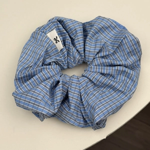 Blue and white plaid oversized scrunchie hair tie with minimalist ribbon logo label