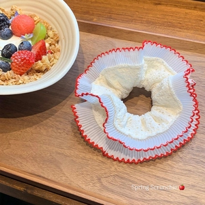 Elegant white lace scrunchie with red scalloped edges and floral embroidery detail