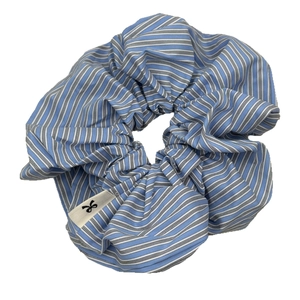 Oversized blue and white striped scrunchie with minimalist woven bow logo label