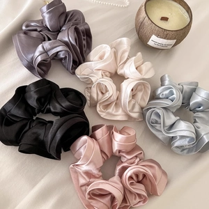 Elegant satin silk scrunchies in five colors including champagne and charcoal grey
