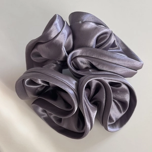 Elegant satin silk scrunchie in deep smoky grey with a premium metallic gloss finish