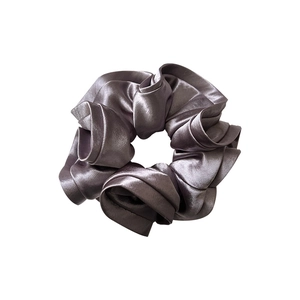 Deep purple satin scrunchie with silky luster and elastic pleated texture on white background