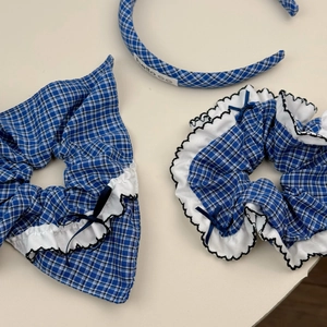 Détail du serre-tête et chouchous à carreaux bleus avec volants et nœuds