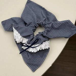 Detailed macro view of the blue gingham fabric headband with lace trim and ribbon bow