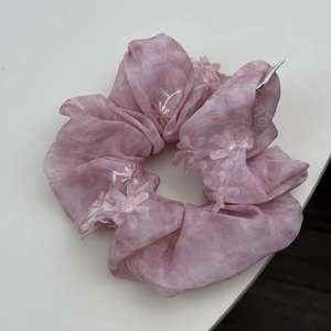 Detail of dusty pink organza scrunchie with delicate 3D floral embroidery textures
