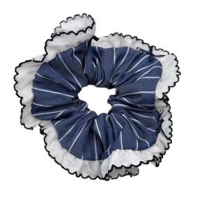 Blue plaid scrunchie with white lace trim and black embroidery on a white background