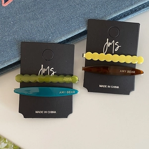 Minimalist acetate hair clip set in wave and spindle shapes with vibrant color-block finish