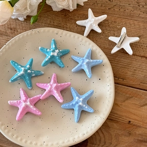 Barrettes à cheveux en forme d'étoile de mer bleue sur plateau pour style de plage
