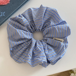 Blue and white striped scrunchie fabric hair tie with brand label for women