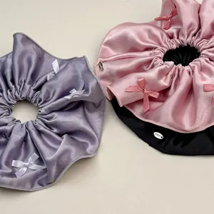 Elegant satin bow scrunchies in lavender, pink, and black for ballet-core hair styling