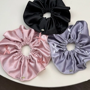 Three-piece satin scrunchie set in pink black and purple with delicate ribbon bows