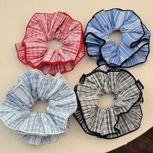Set of four minimalist striped and checkered scrunchies in varied colors for women