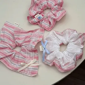 Pink striped cotton scrunchies with lace, ribbon bows and blue buttons in sweet style