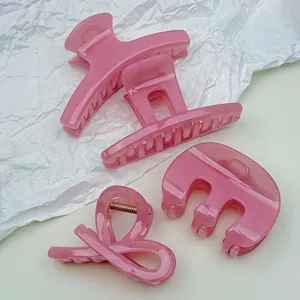 Set of four jelly pink minimalist hair claws in various shapes with glossy finish