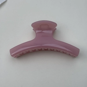 Minimalist jelly pink hair claw clip with smooth curved design and resin texture finish