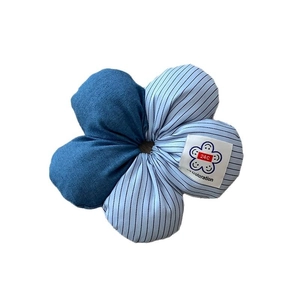 Floral striped hair tie with denim blue patchwork petals and a square white logo label