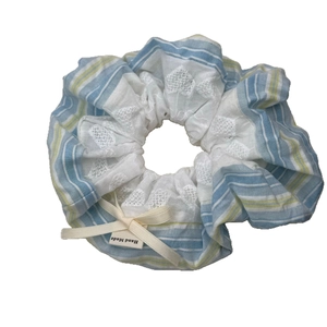 Blue and white striped scrunchie with lace embroidery and a delicate bow detail