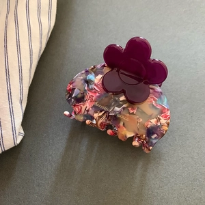 Detail of floral acetate hair claw with purple flower and Barrette la France logo