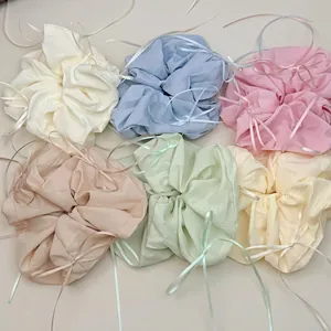 Set of six colorful satin ribbon scrunchies in pastel tones for ballet core hairstyles