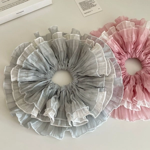 Elegant oversized layered tulle scrunchies in dusty blue and pink with ruffled edges
