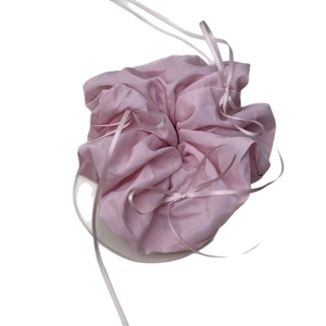 Pink ribbon bow scrunchie in French ballet style for elegant low ponytail styling