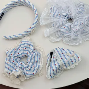 Detail of blue striped lace scrunchie set with red hearts and pearl flower headband