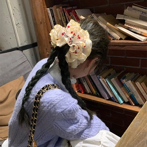 Sweet white organza scrunchie with red cherry embroidery and yellow hem on double ponytails
