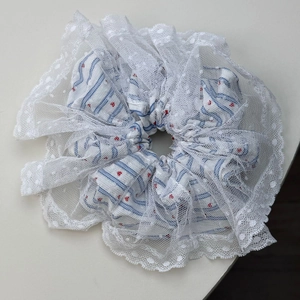 Detail of French ballet style lace scrunchie with blue stripes and red heart floral prints