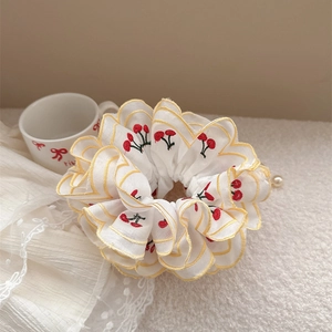 White oversized scrunchie with red cherry embroidery, yellow wavy edges and pearl charm