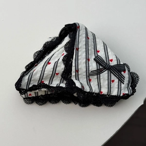 Close-up of heart print hair scrunchie with striped fabric and black lace trim detail