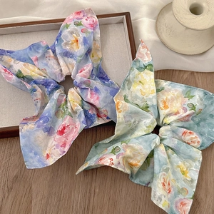 Floral oil painting silk scrunchies with large pleats on a wooden aesthetic background